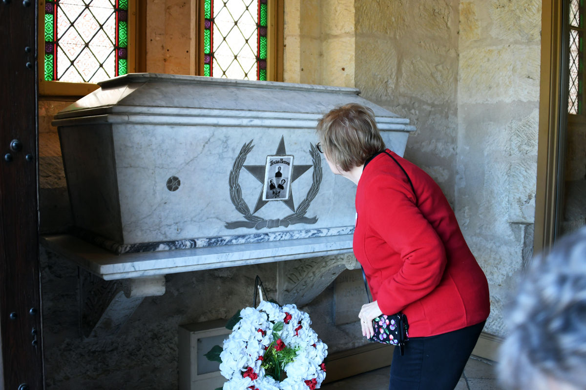 135 Donna Driewer with the tomb of the Alamo heroes.JPG